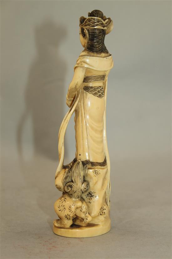 A Japanese ivory group of an immortal and a shi-shi, early 20th century, 18cm